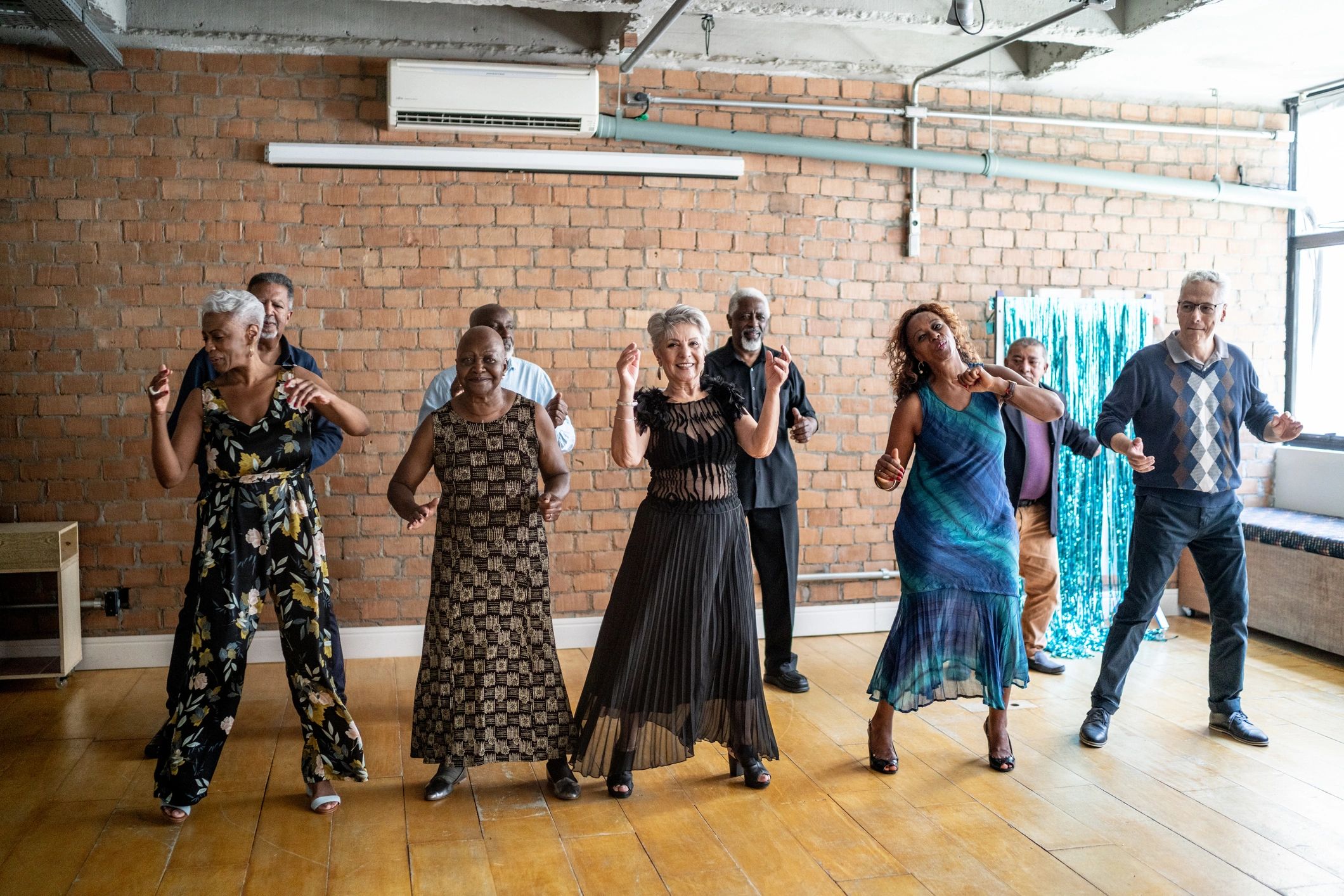 Friends dancing together in a hall