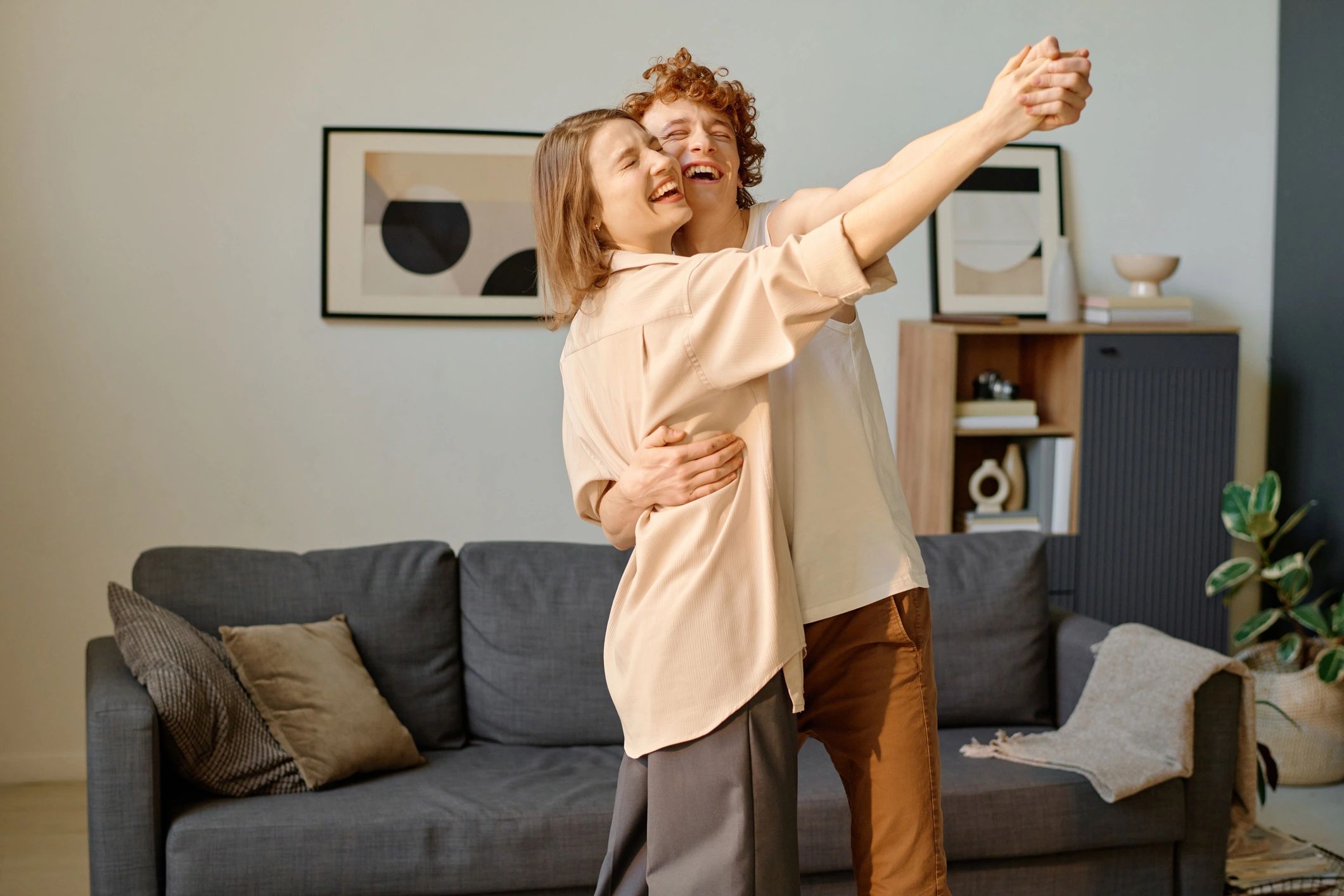 Adult couple dancing together in a bright room
