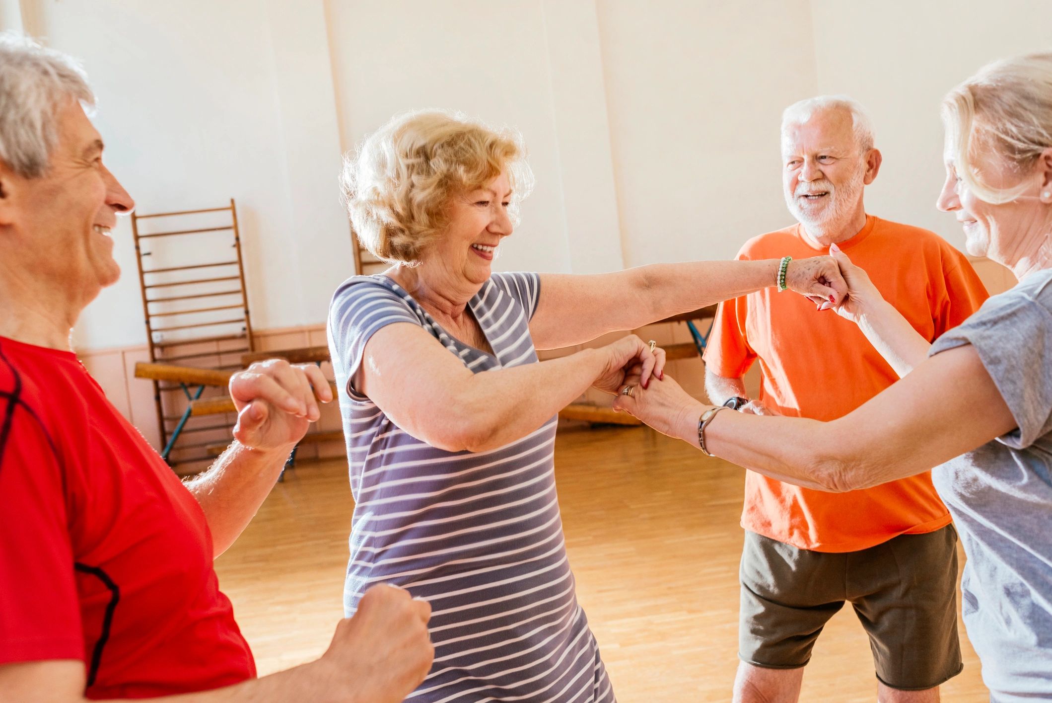 Adults enjoying a group dance class